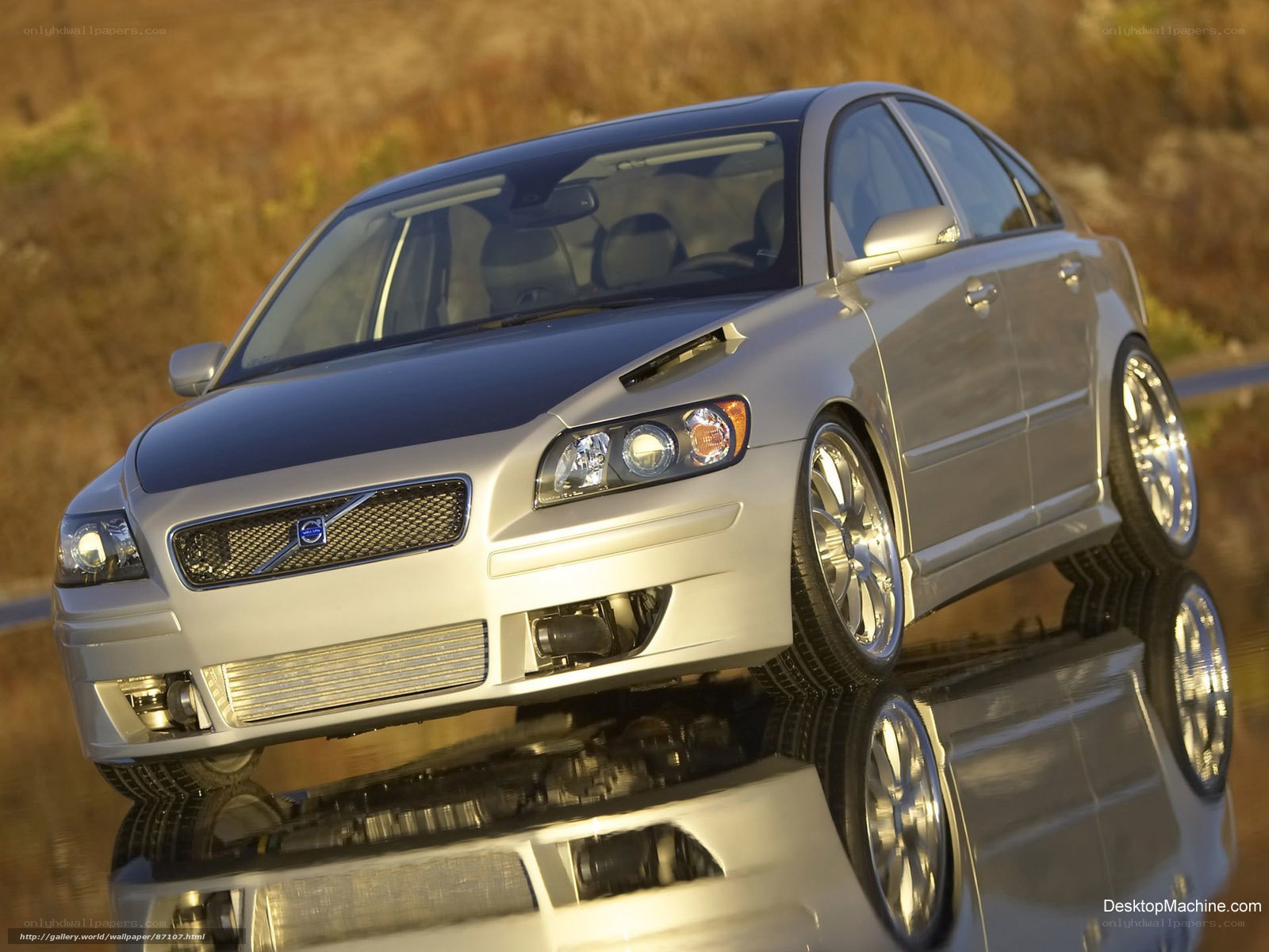 silver volvo sedan on reflective surface