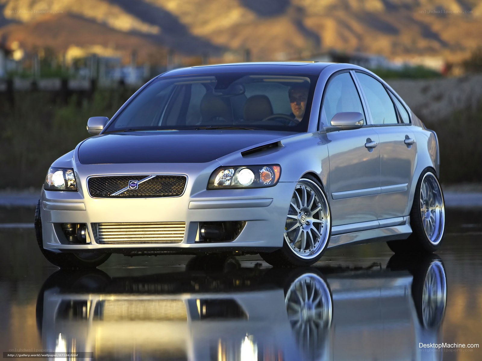 silver volvo sedan on wet pavement