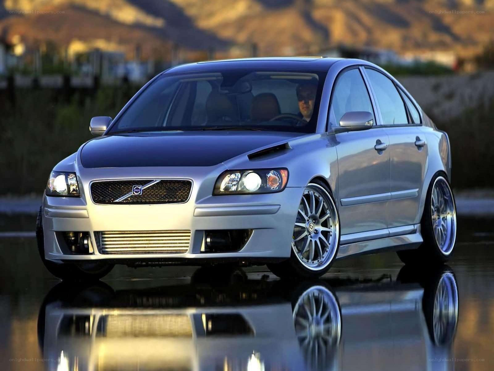 silver volvo sedan on wet surface