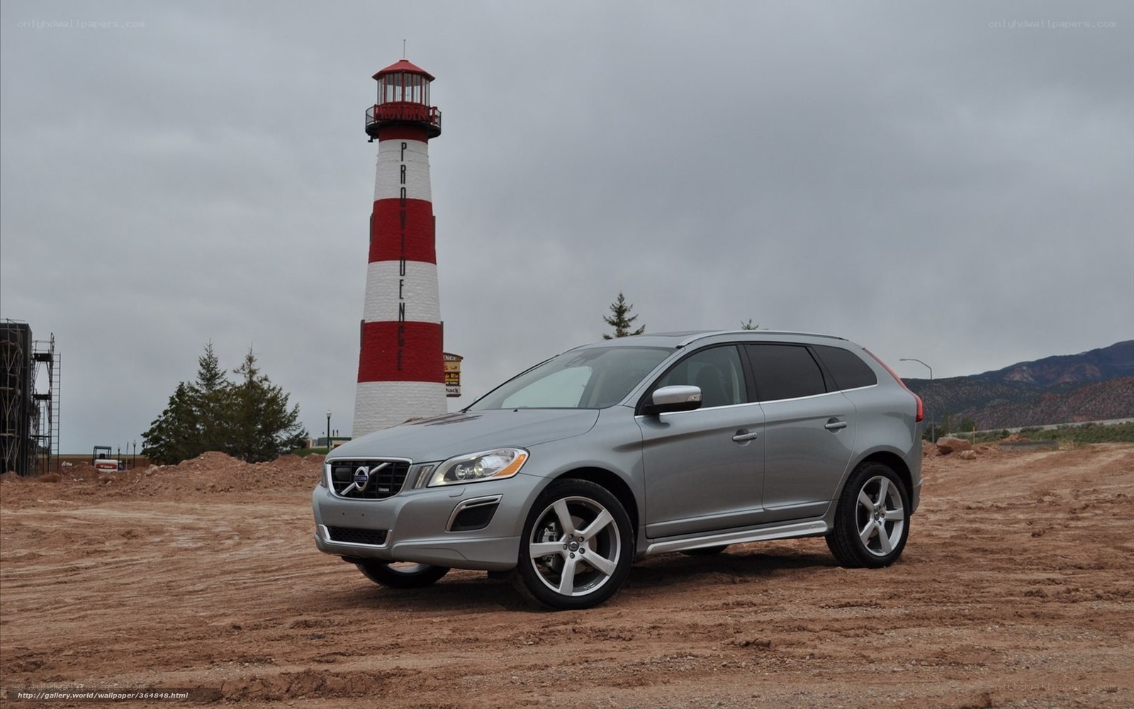 Silver Volvo XC60 near lighthouse
