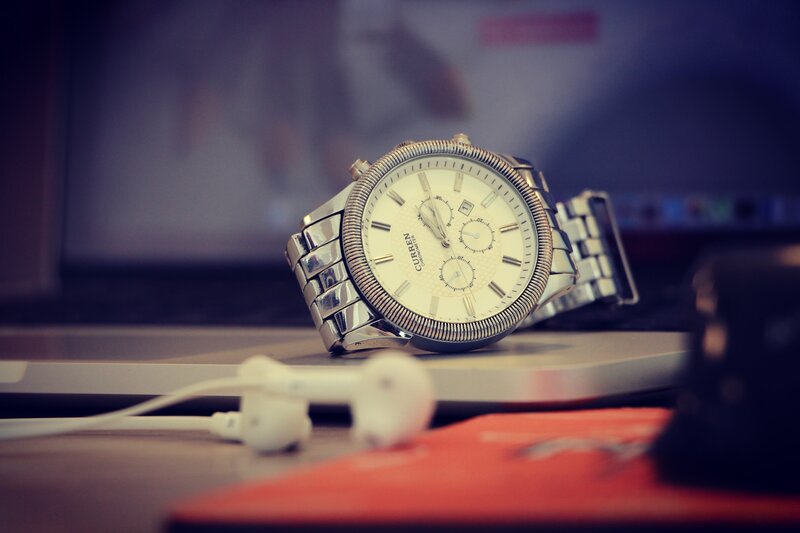 silver watch on laptop