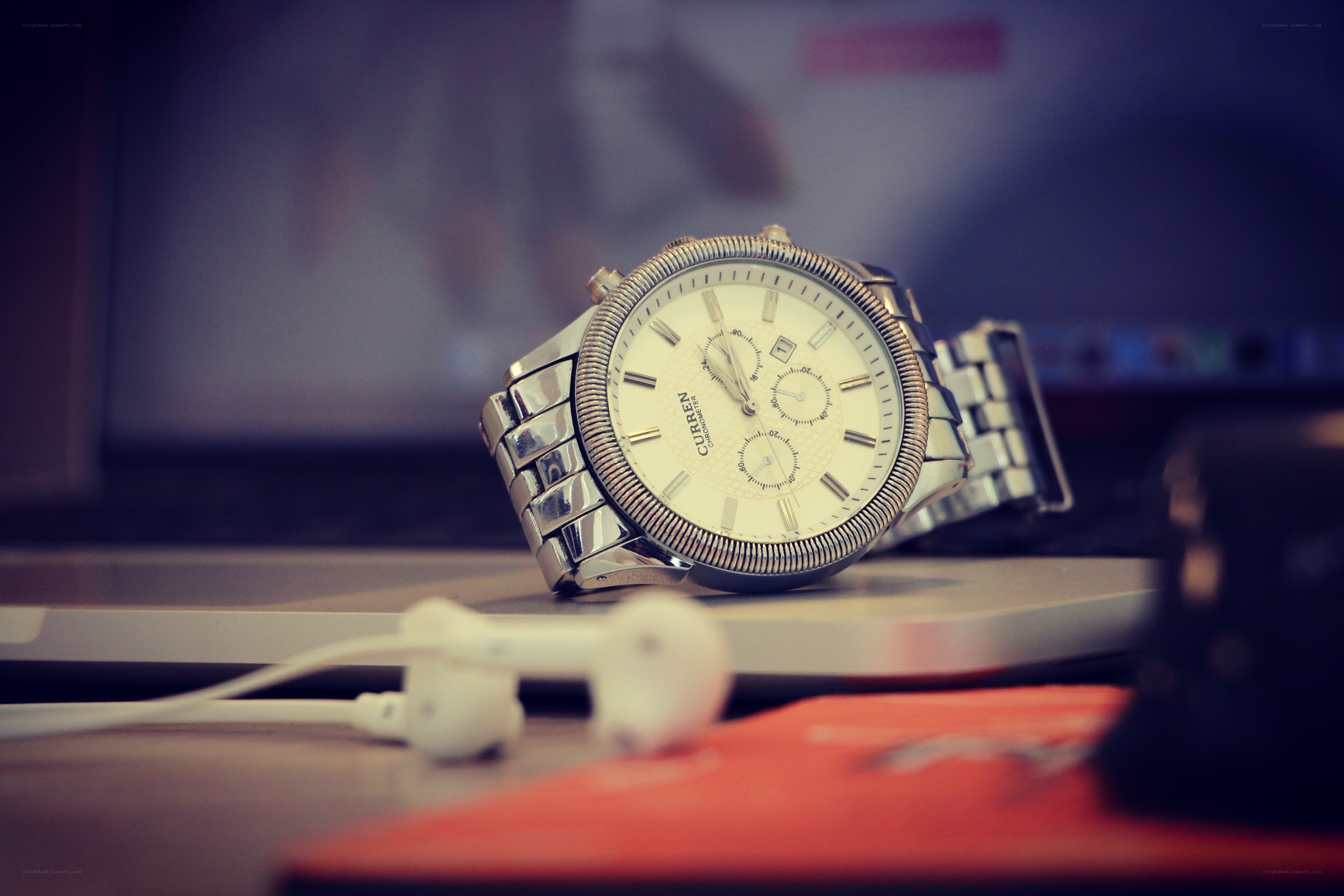 silver watch on laptop