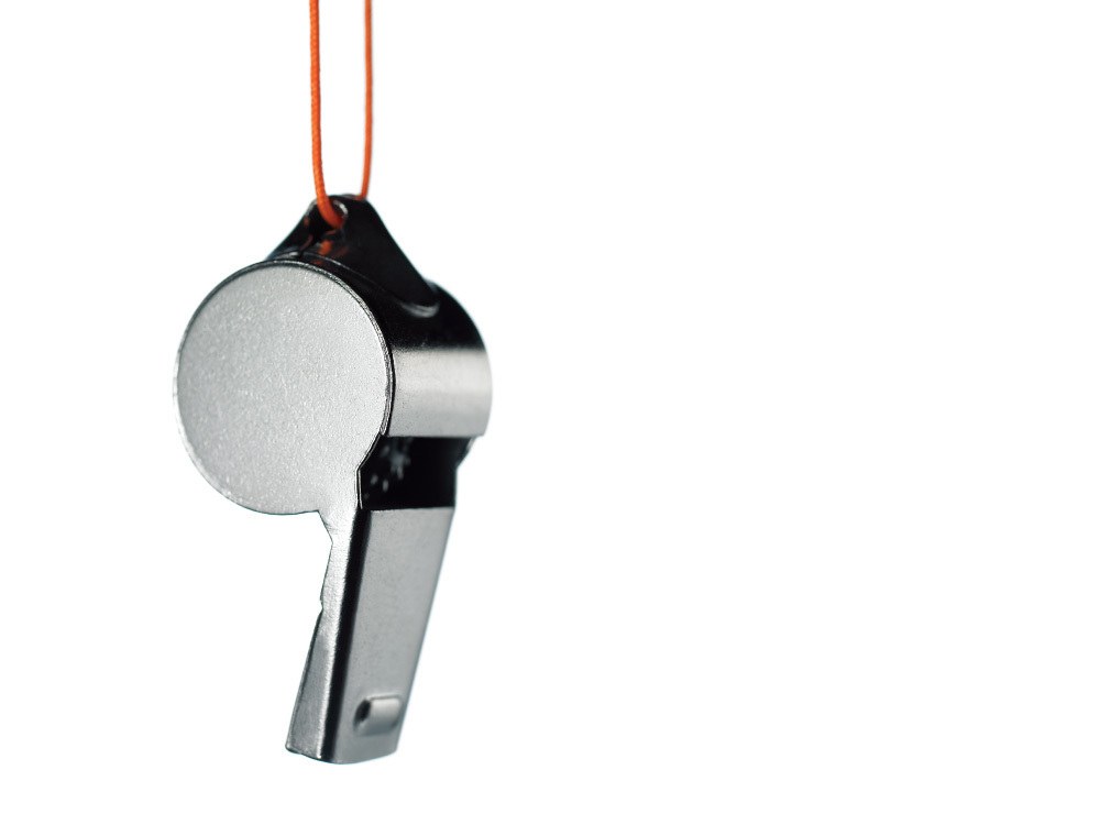 silver whistle on orange cord