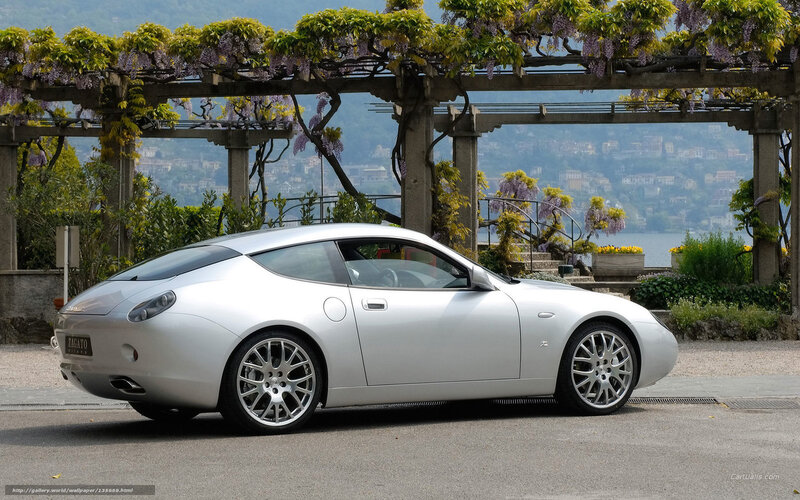Silver Zagato car on a scenic road