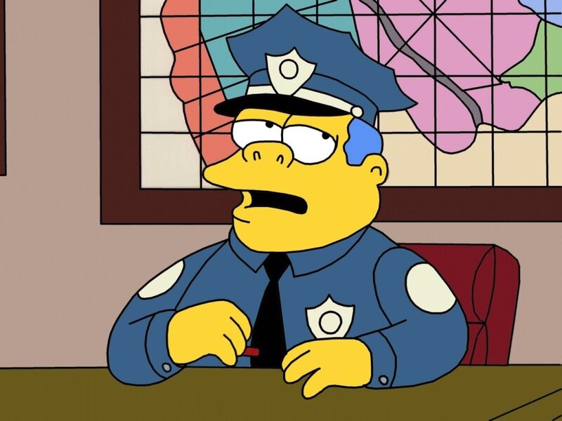 Simpson police officer at desk
