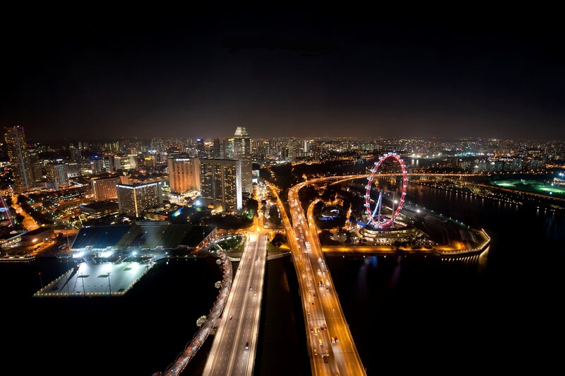 Singapore night skyline with Ferris wheel