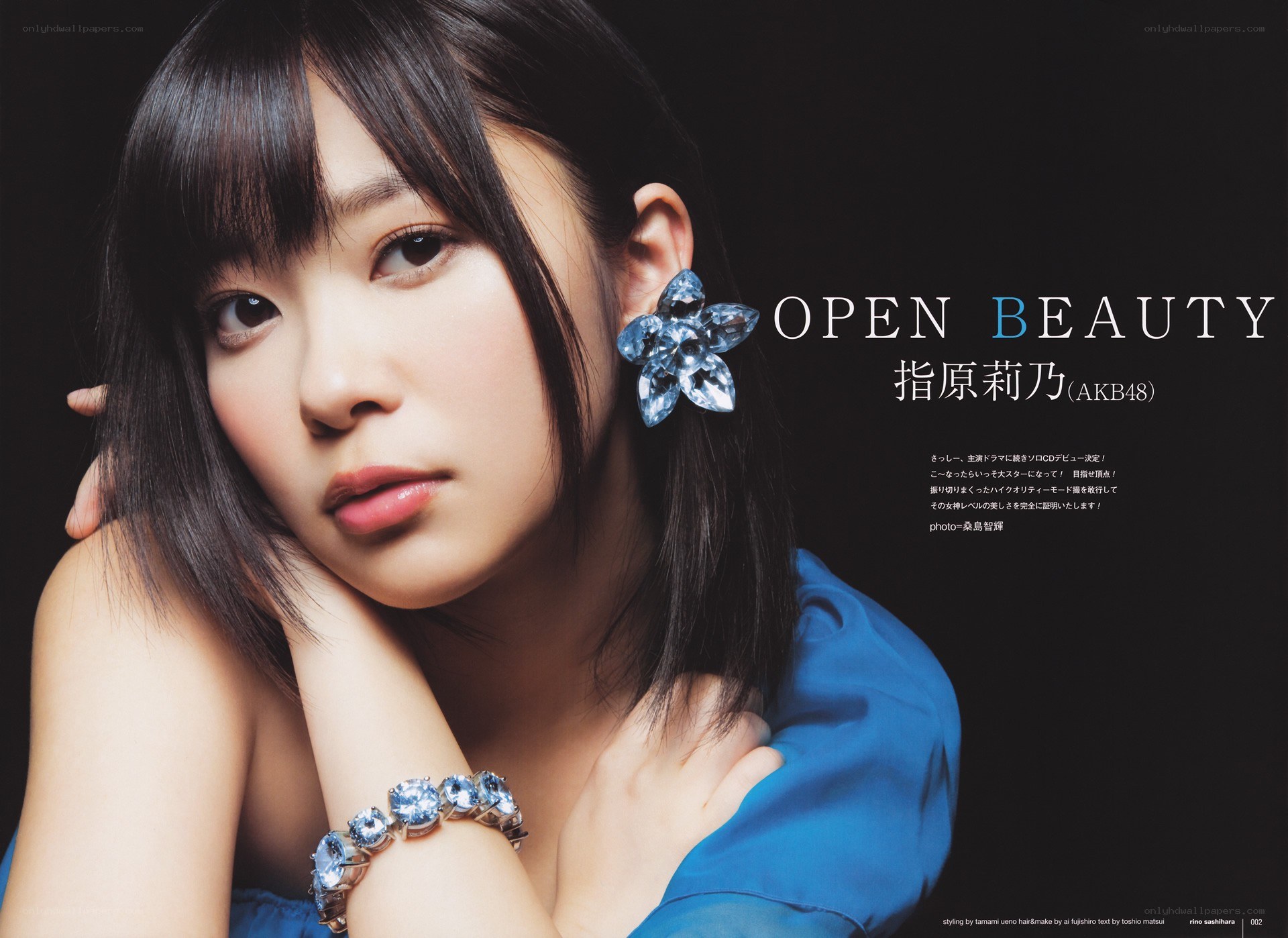 Singer in blue with gem earrings