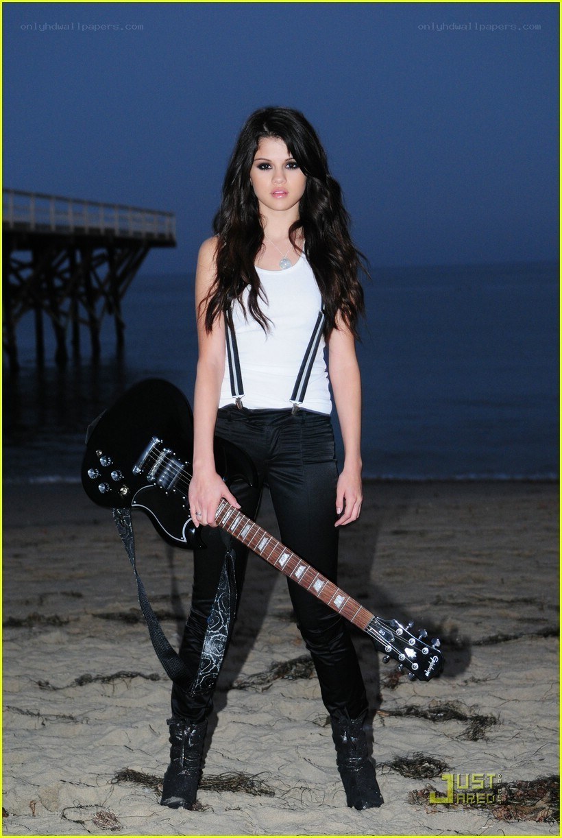 singer on beach with guitar