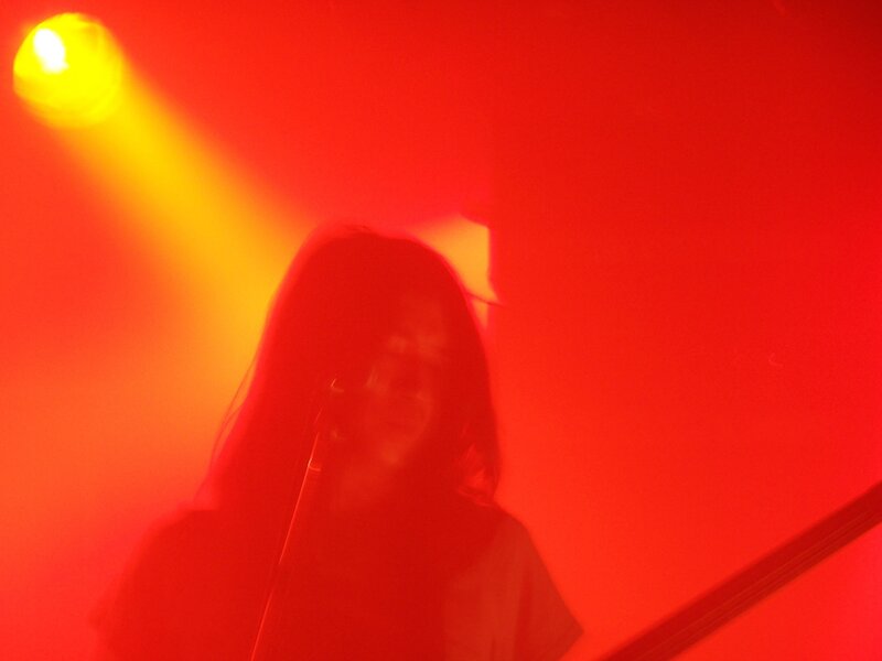 singer on stage under red light