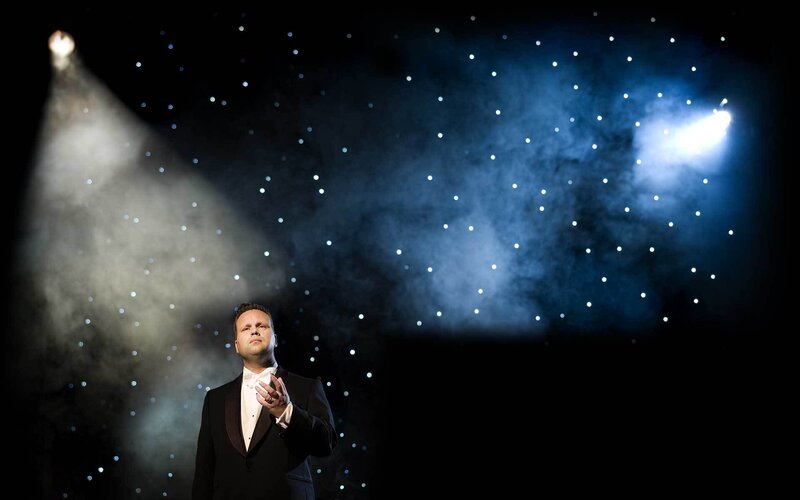 singer on stage under spotlights