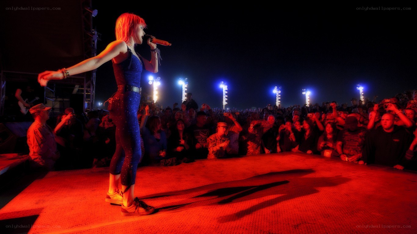 singer performing on stage at night