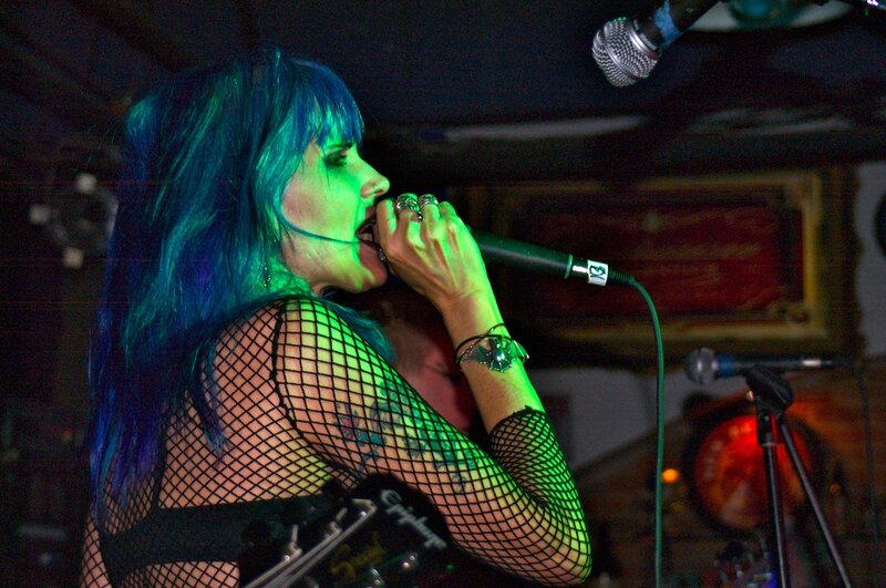 Singer with blue hair performing