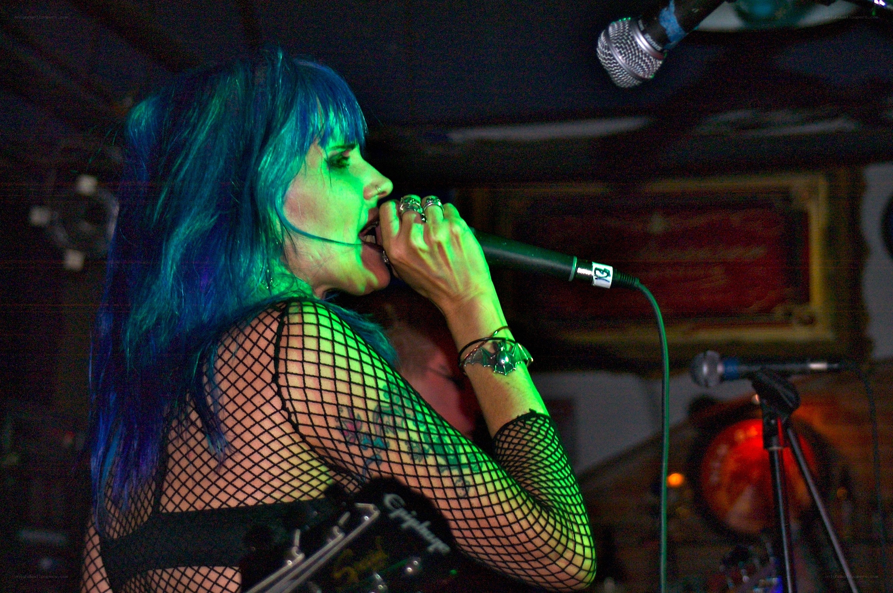 Singer with blue hair performing
