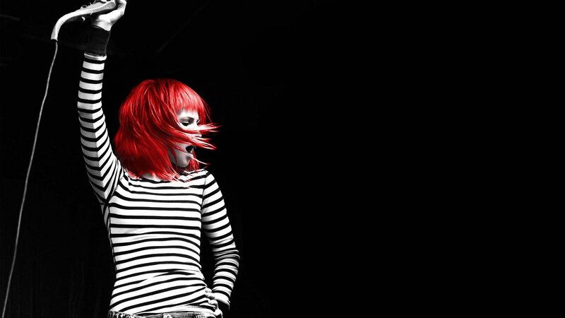 singer with red hair on stage