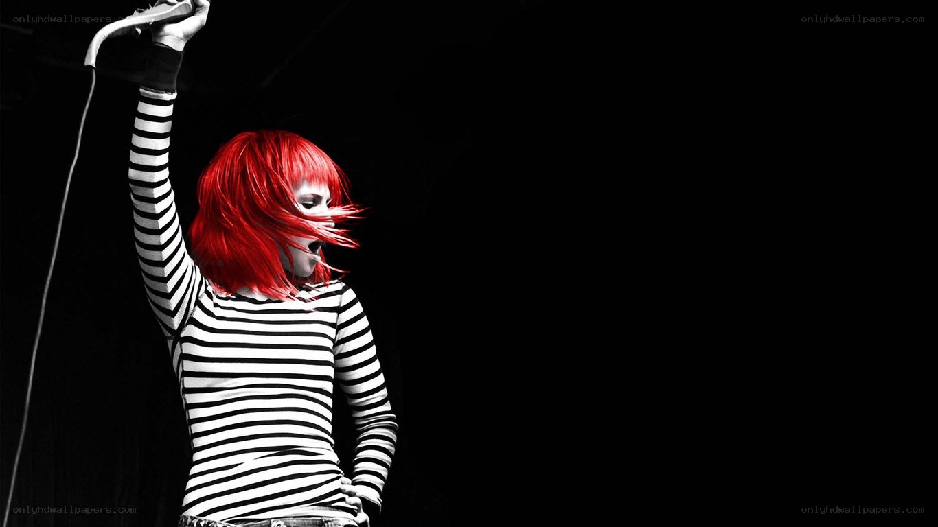 singer with red hair on stage