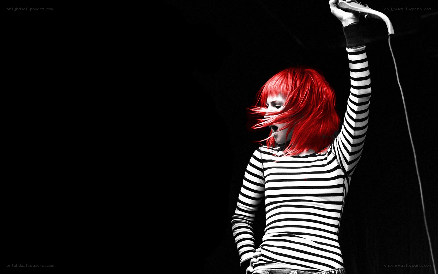 singer with red hair performing