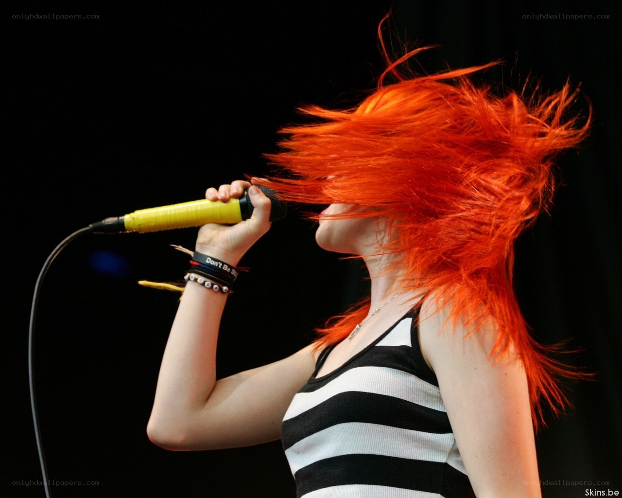 singer with red hair performing