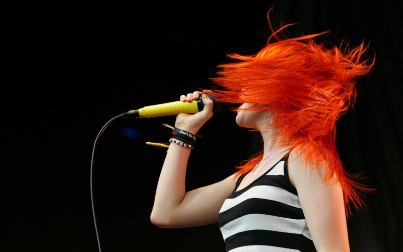 singer with red hair performing