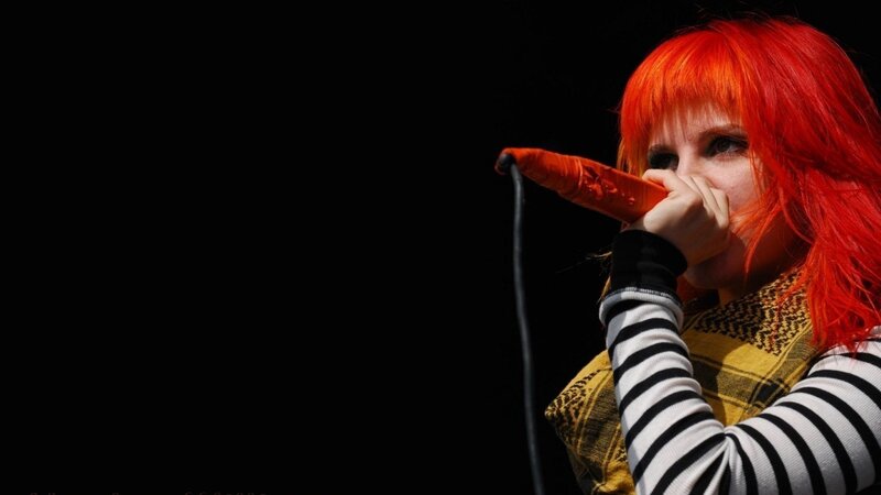 singer with red hair performing