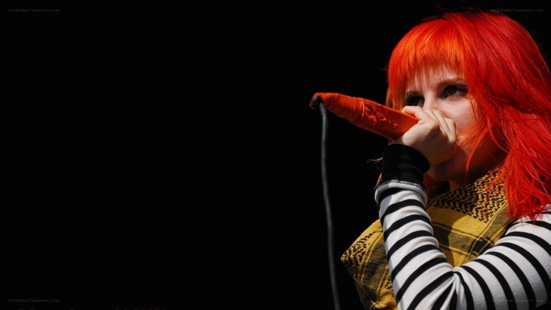 singer with red hair performing