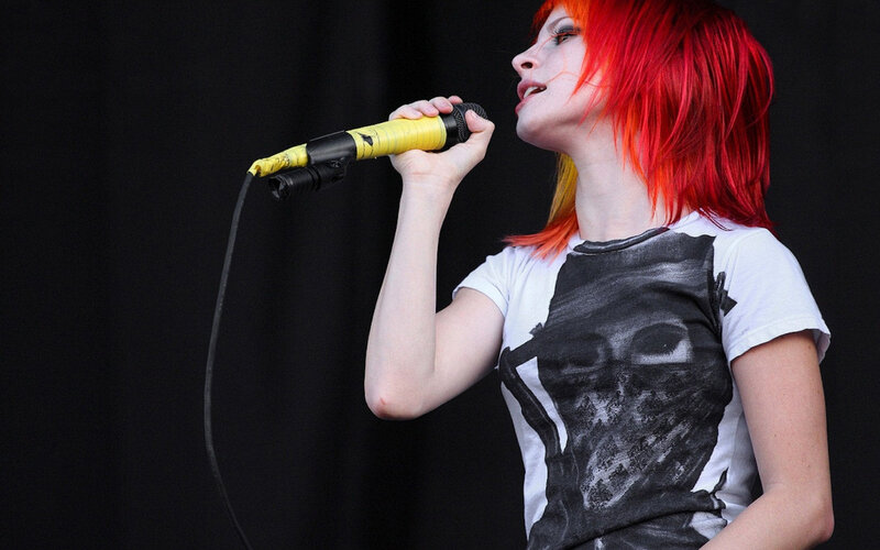 singer with red hair performing