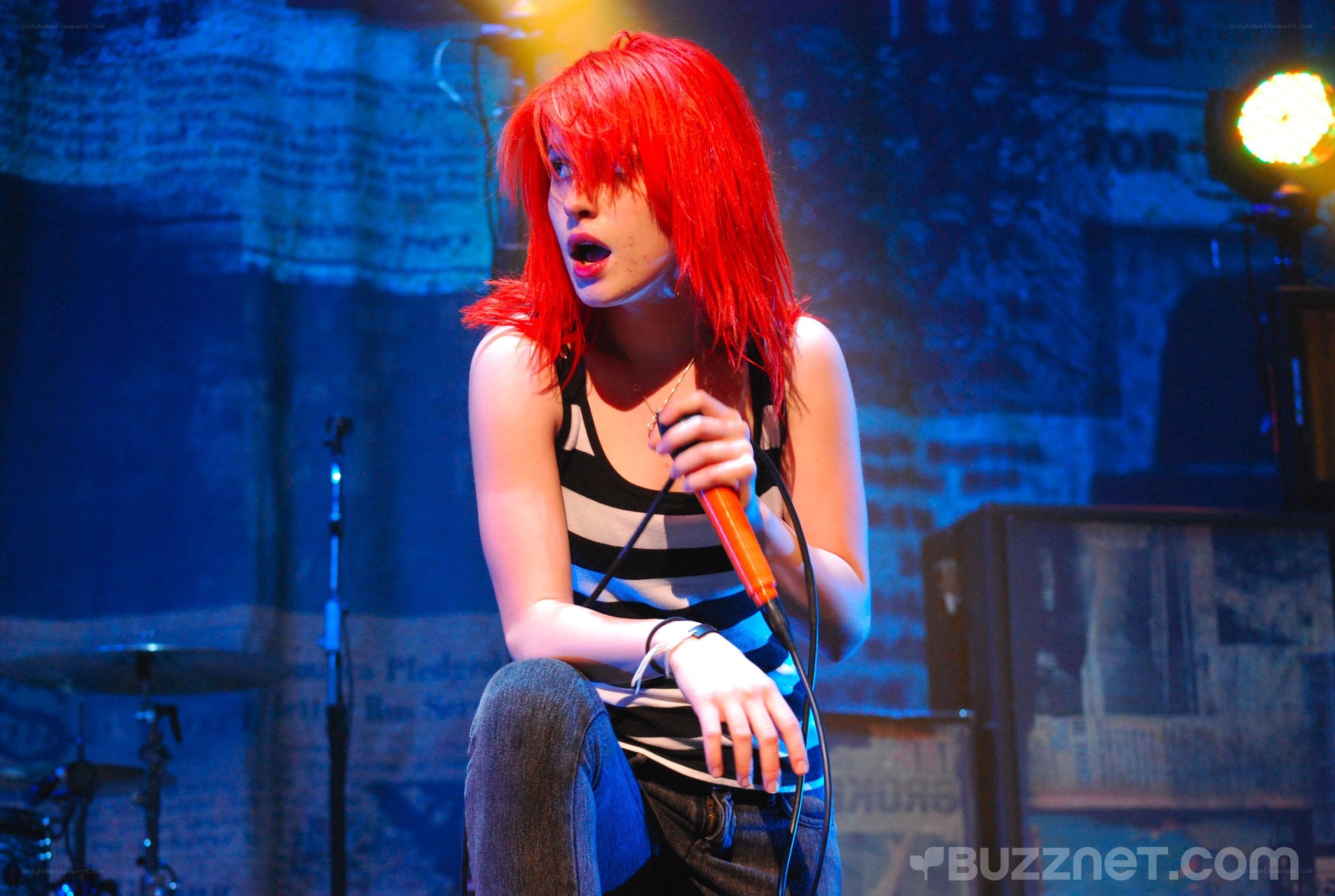singer with red hair performing