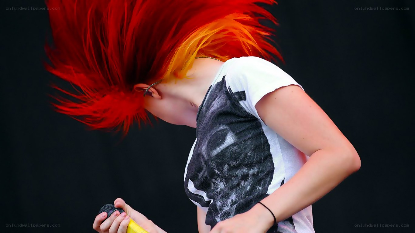 singer with red hair performing