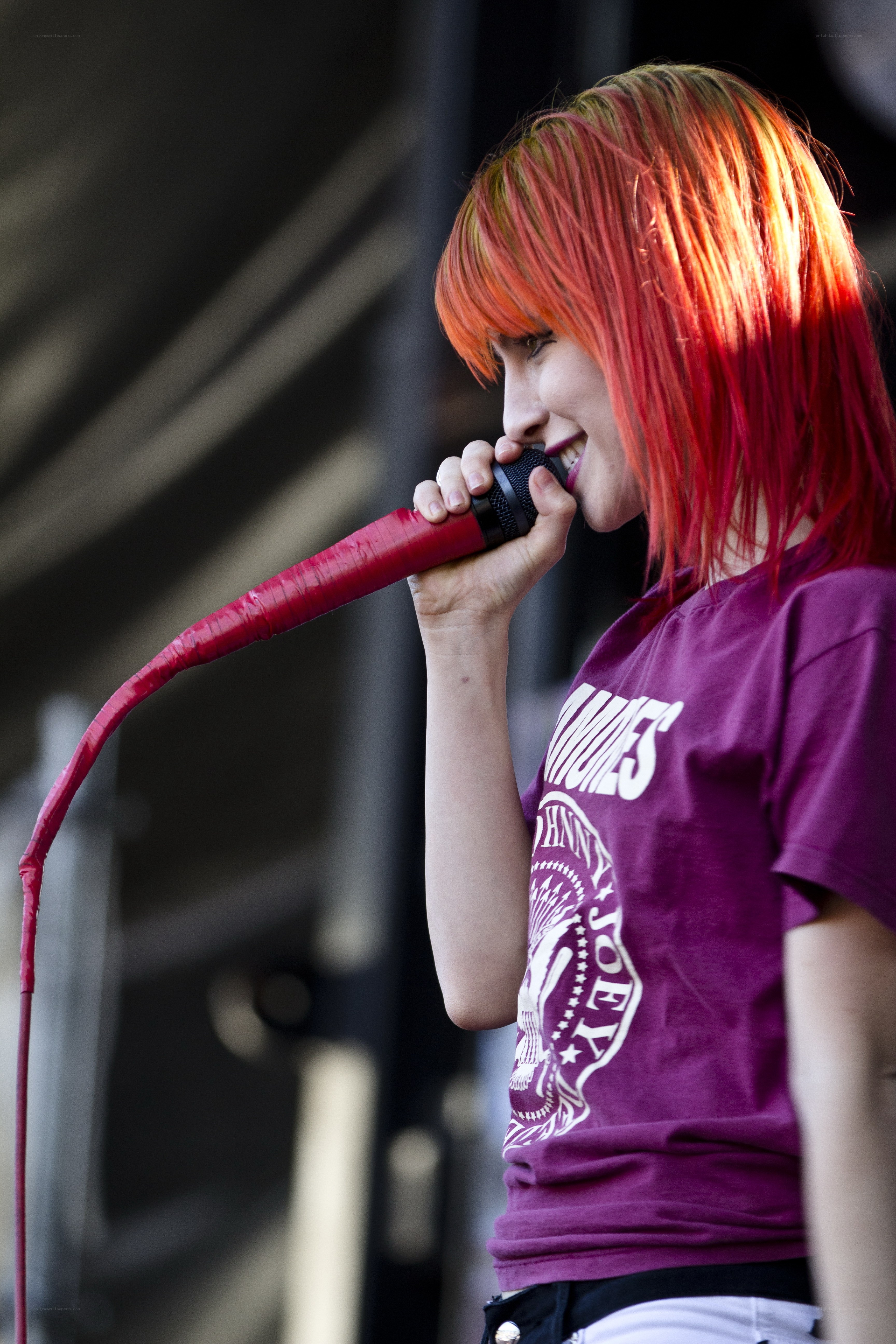 singer with red hair performing