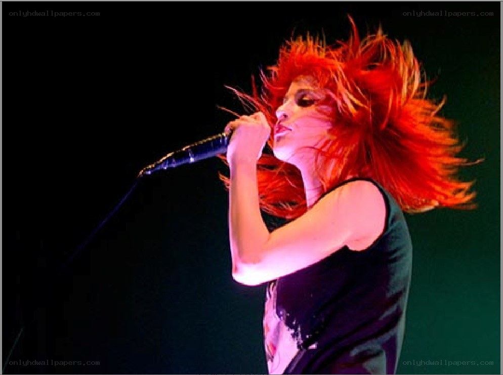 Singer with red hair performing
