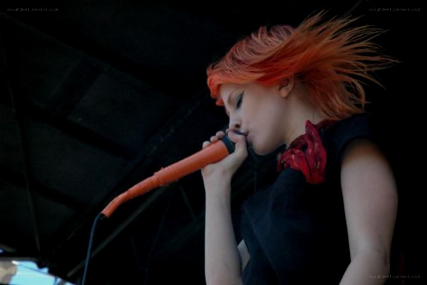 singer with red hair performing