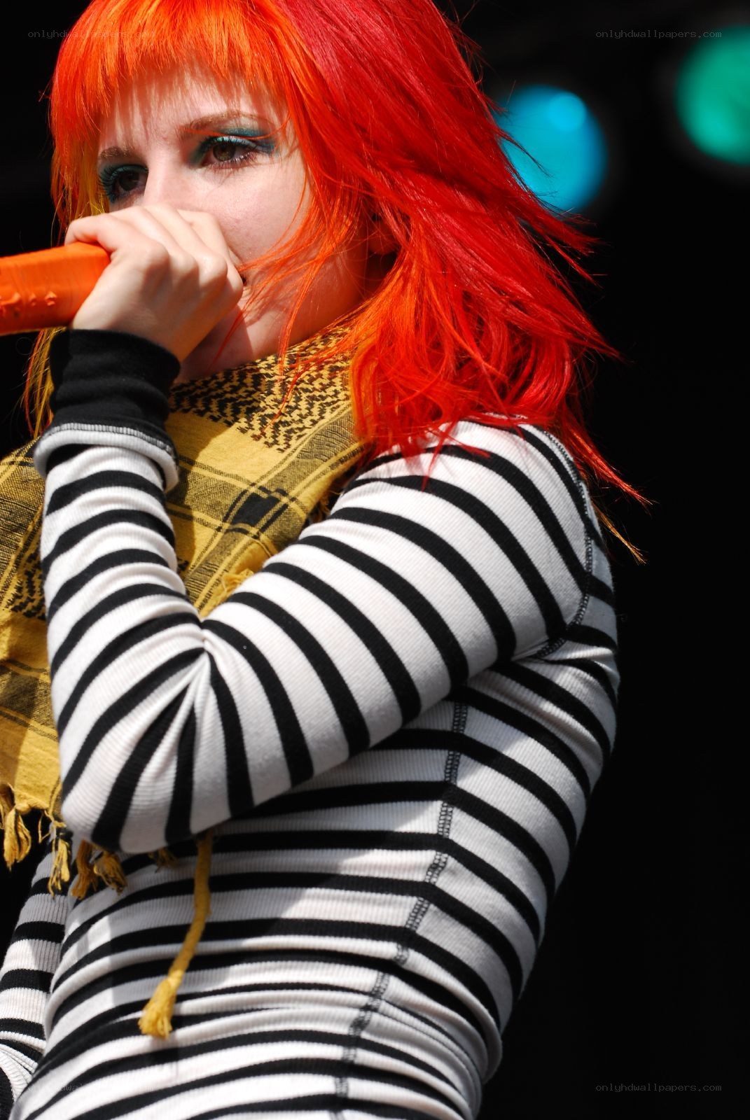 singer with red hair performing