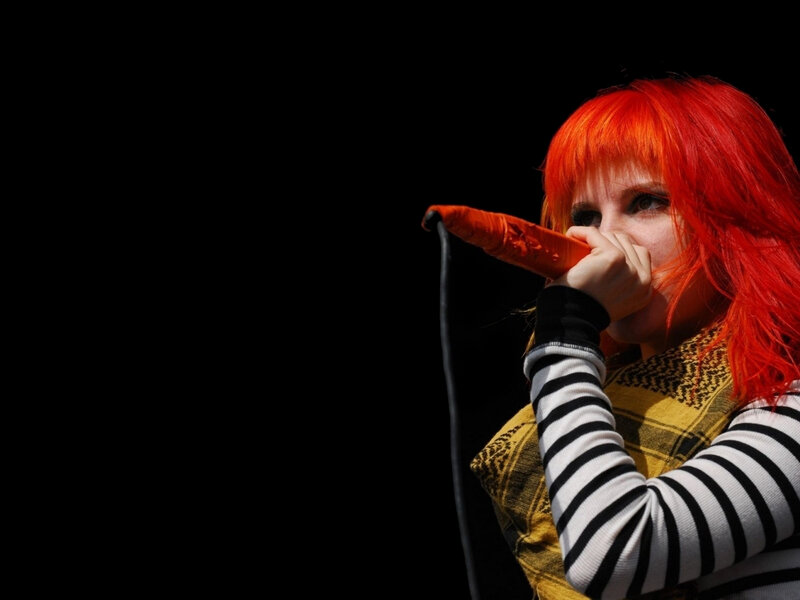 singer with red hair performing