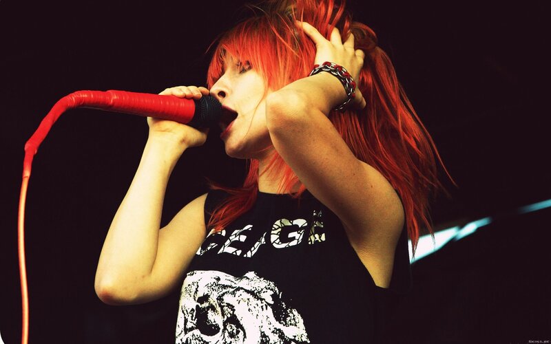 singer with red hair performing