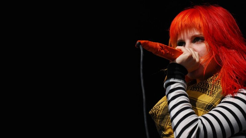 singer with red hair performing