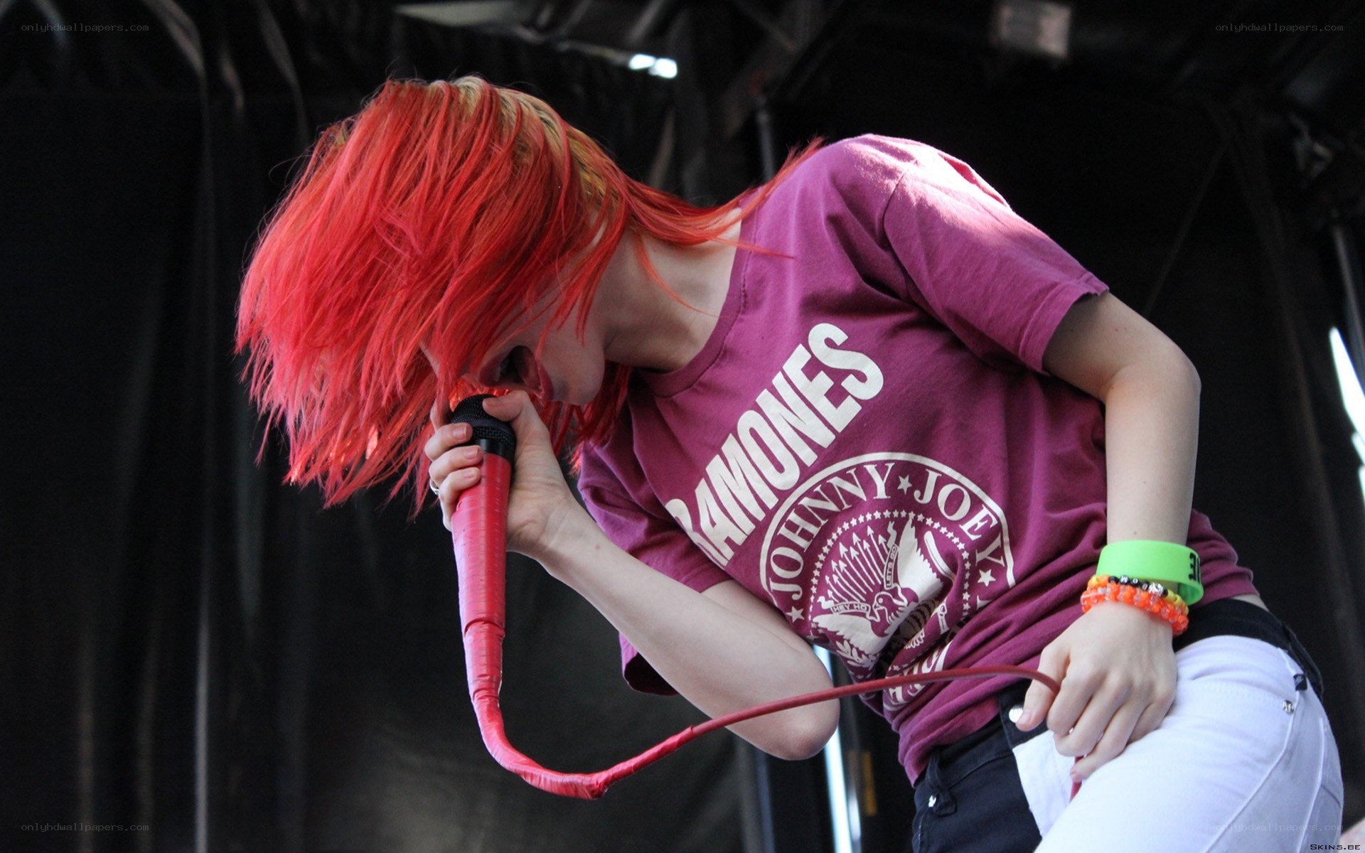Singer with red hair performing