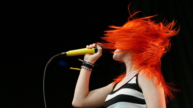 singer with red hair performing