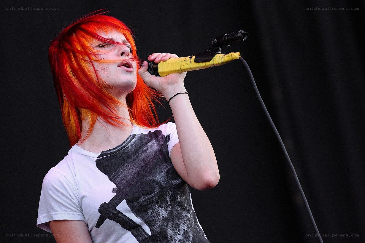 singer with red hair performing