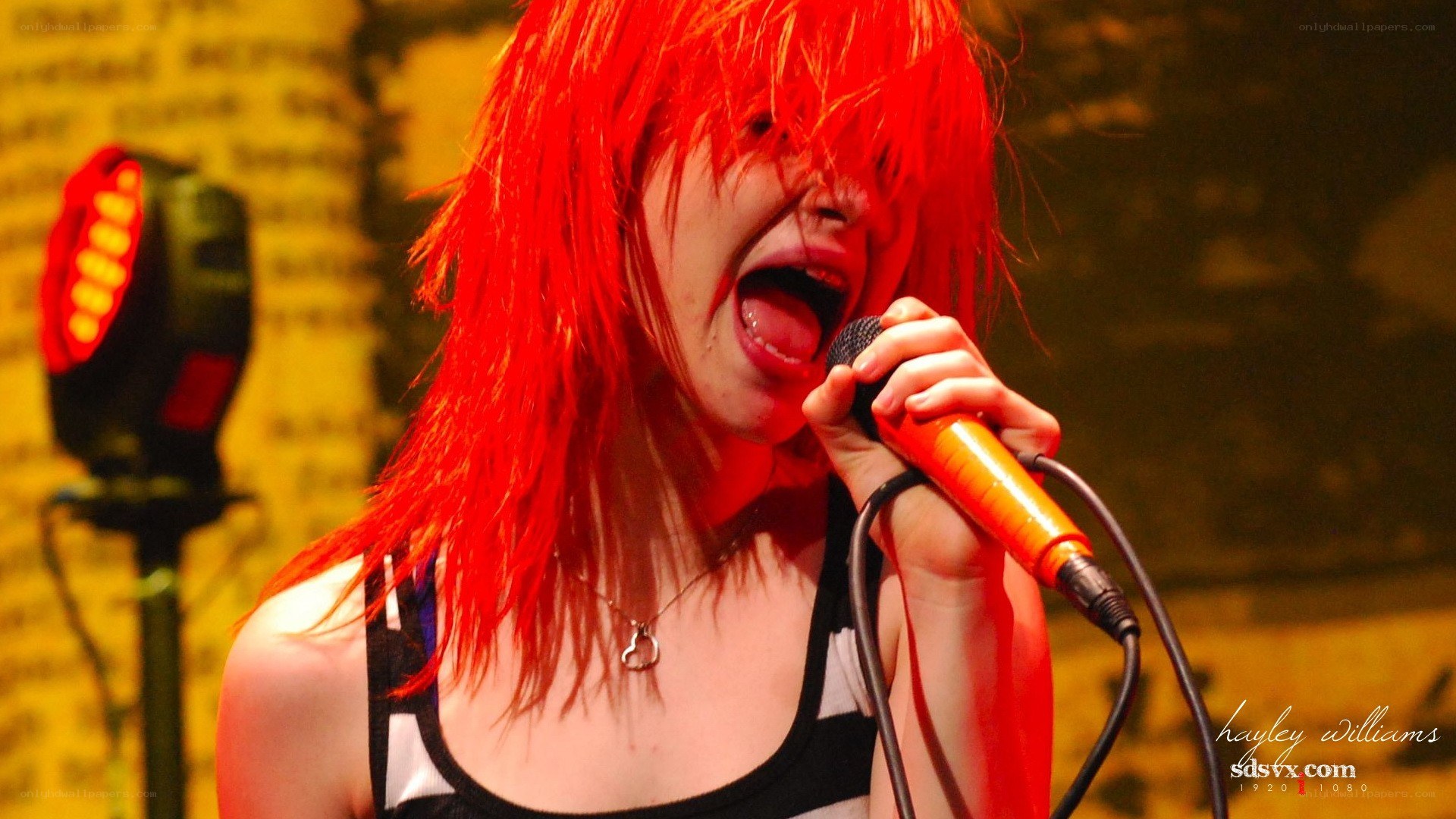 singer with red hair performing