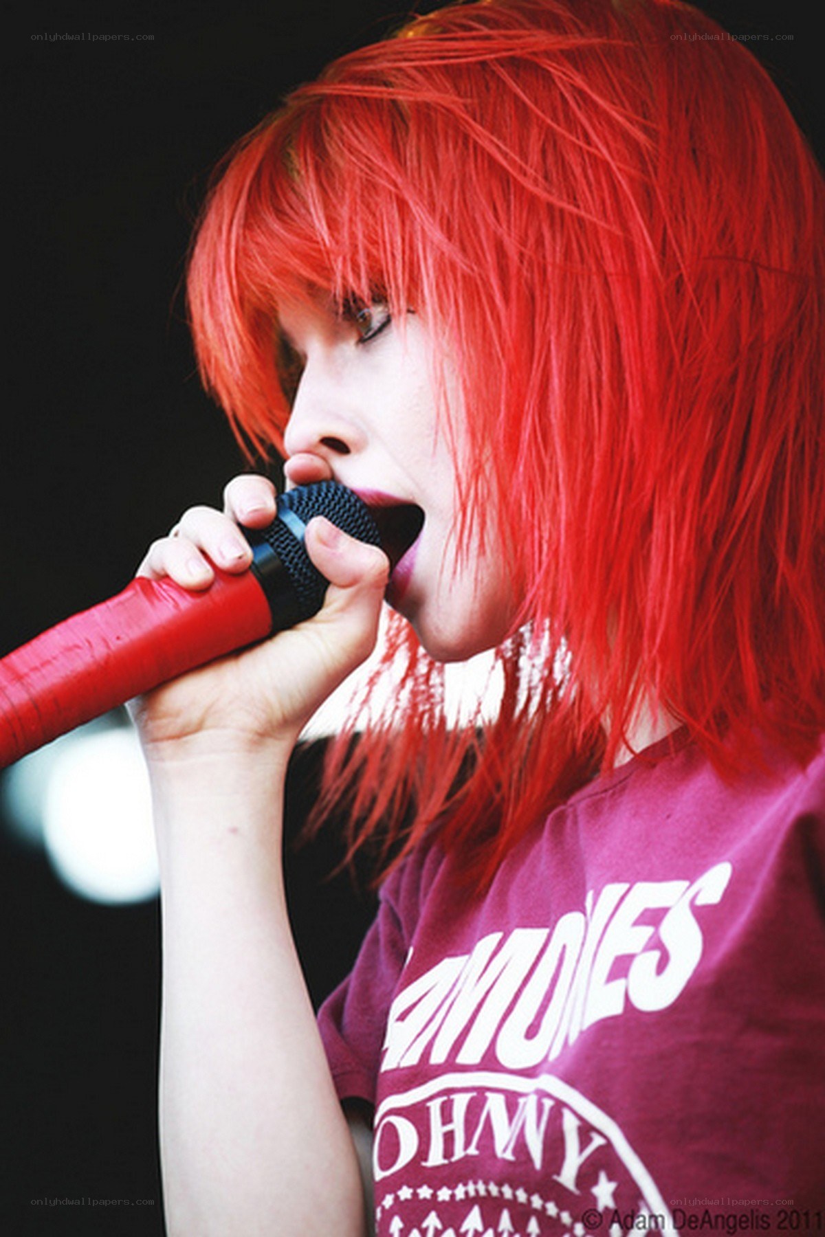 singer with red hair performing