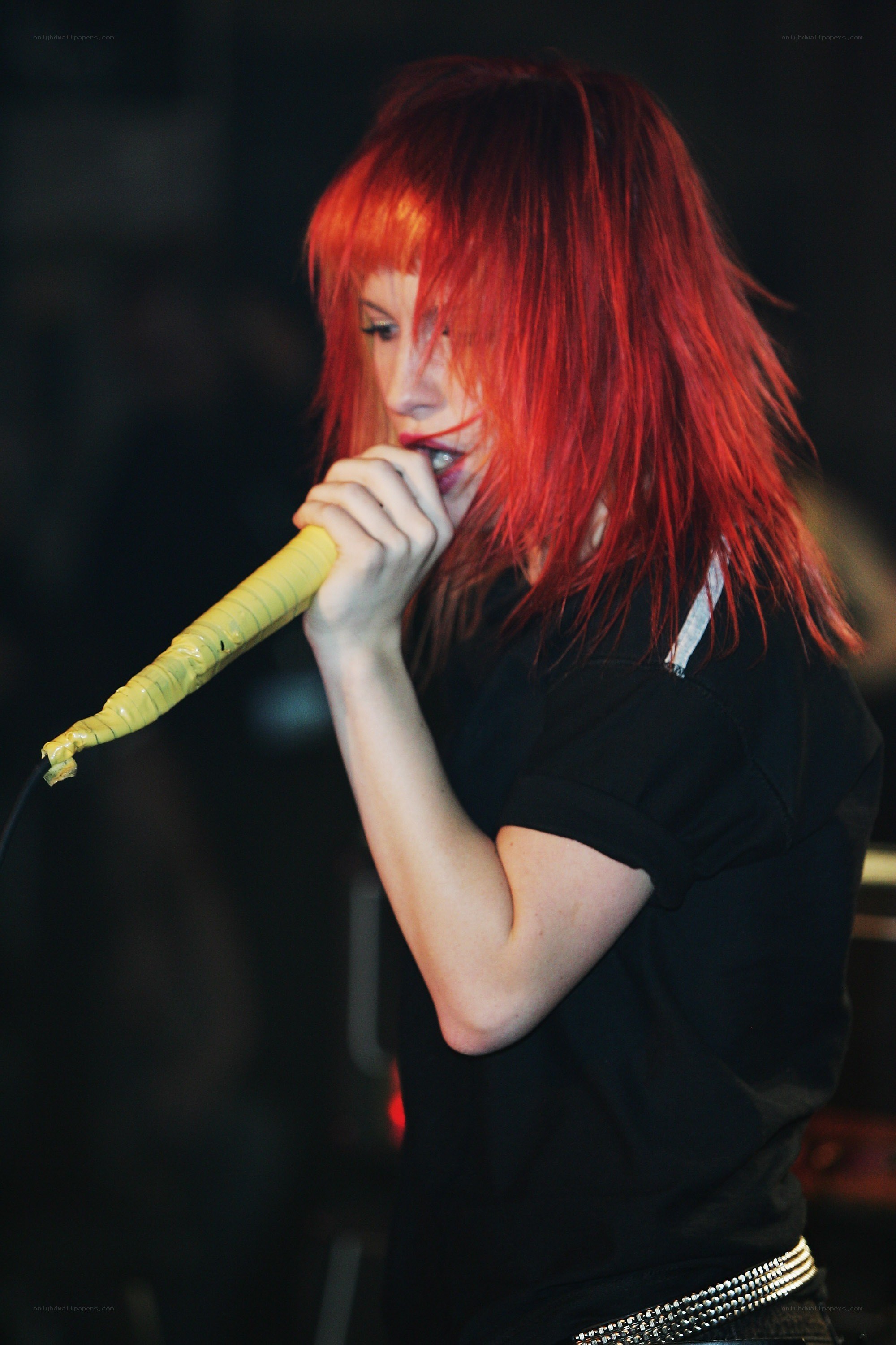 singer with red hair performing