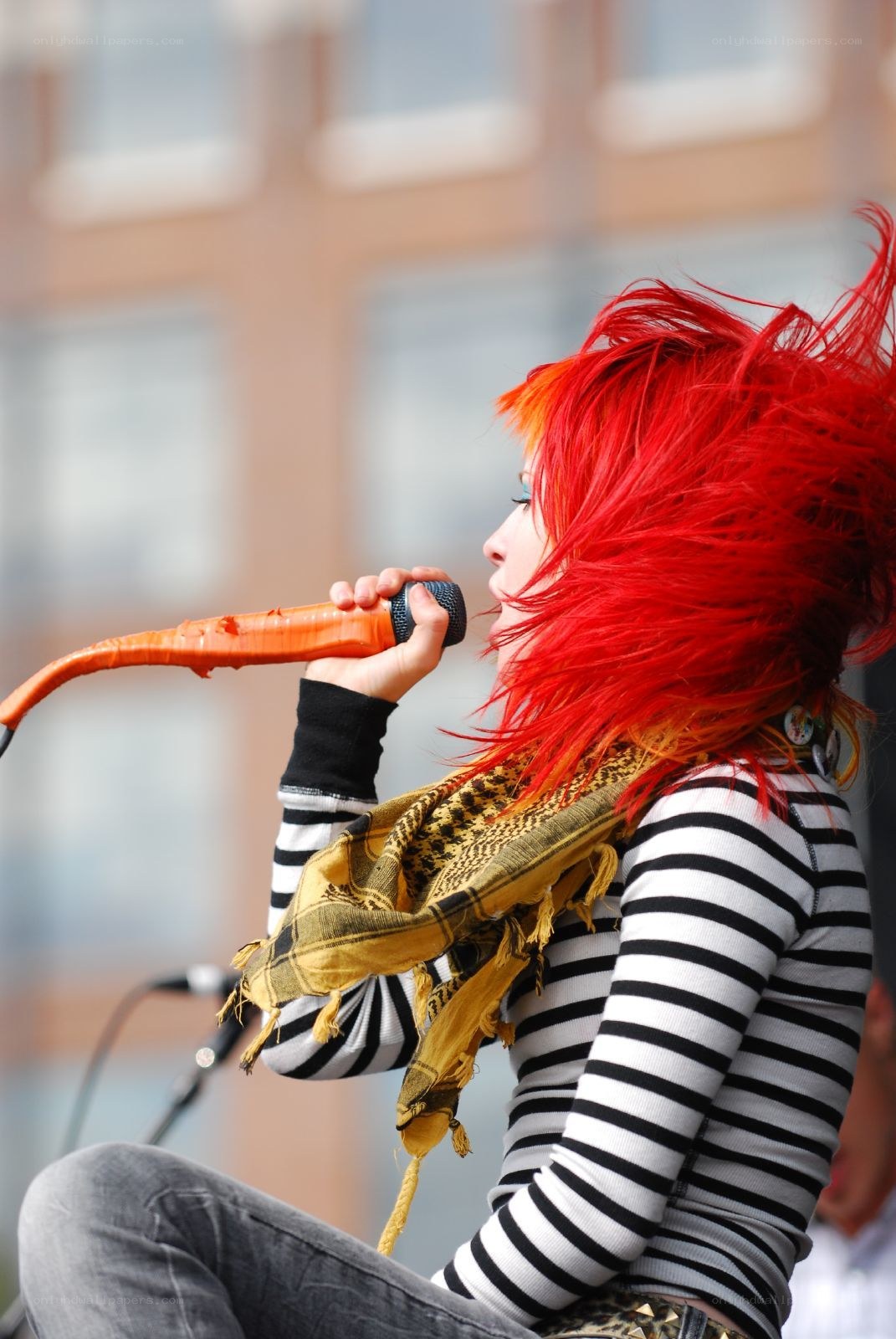 singer with red hair performing