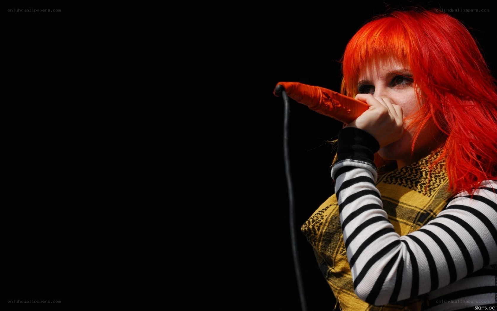 singer with red hair performing