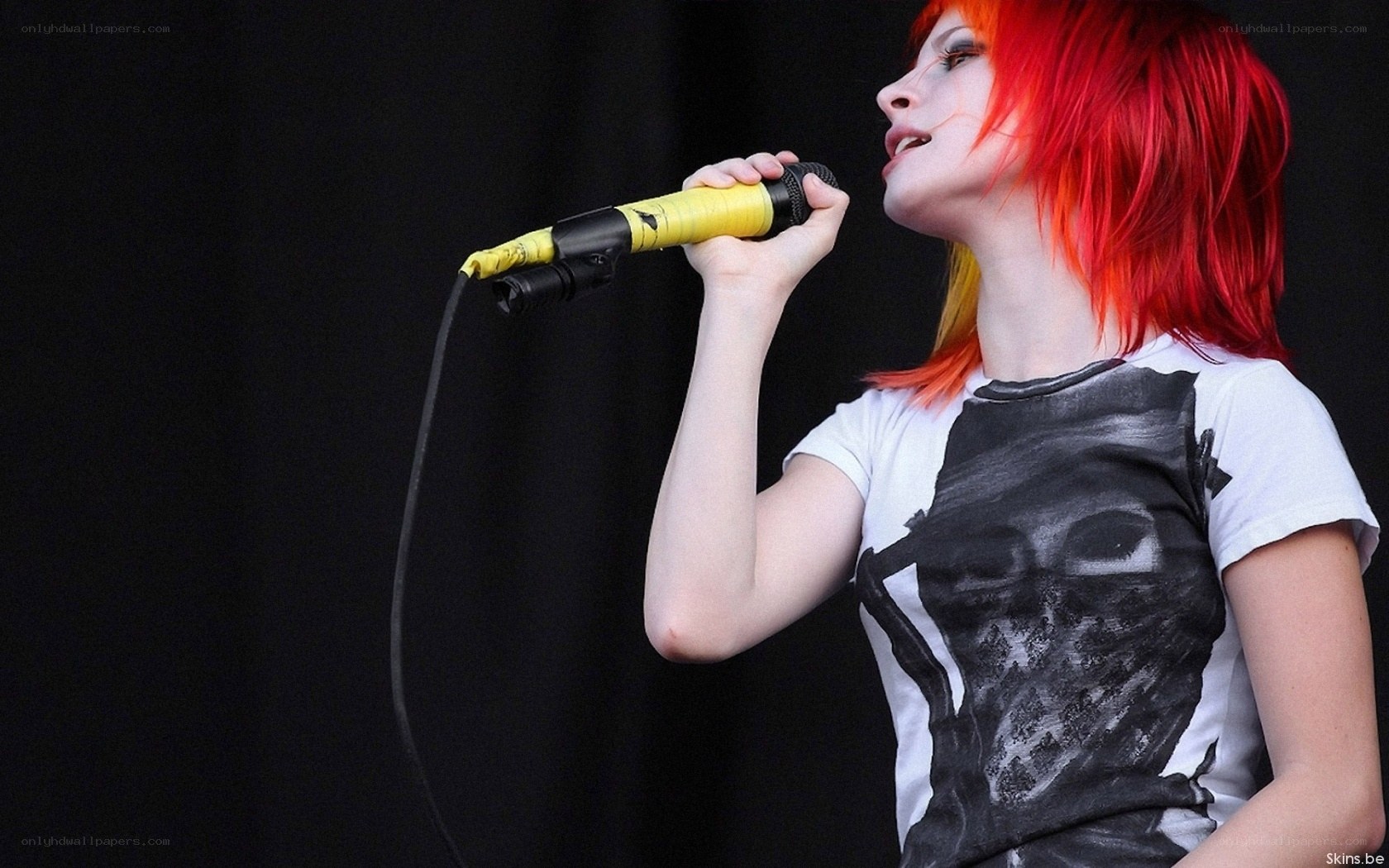 singer with red hair performing