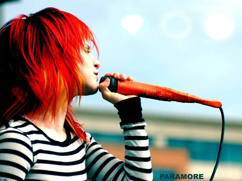 singer with red hair singing into microphone