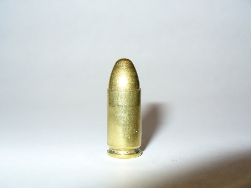 single bullet on white surface
