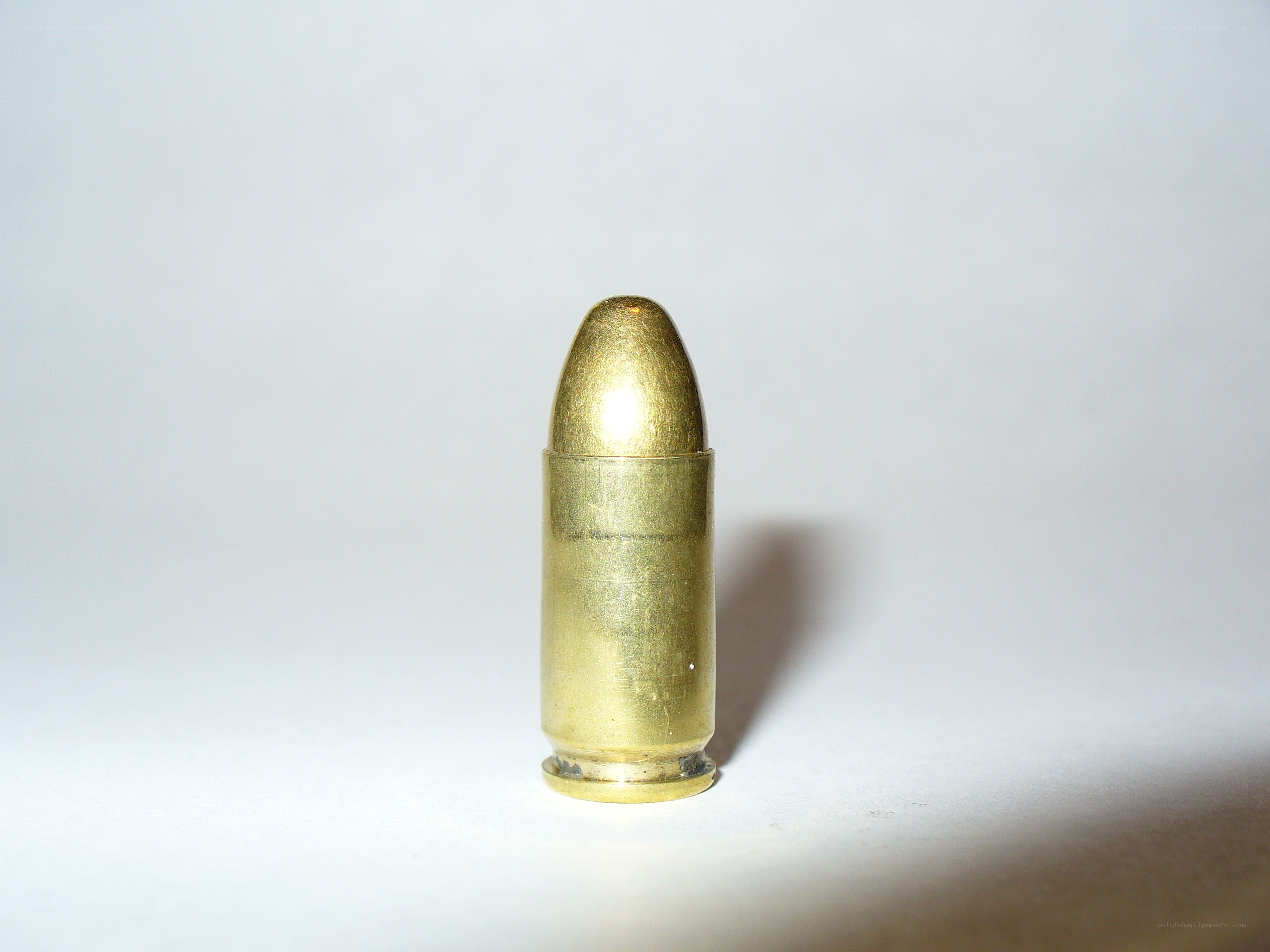 single bullet on white surface