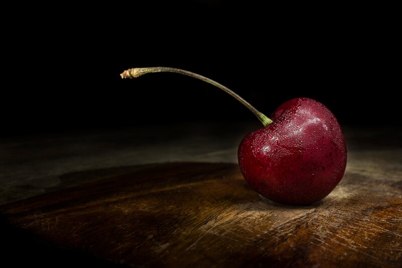 Single Cherry on Wood
