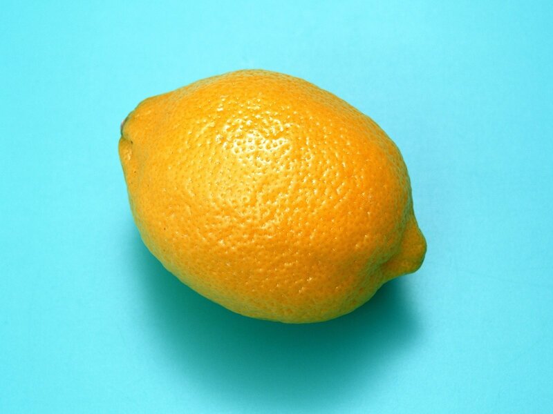 single lemon on blue background