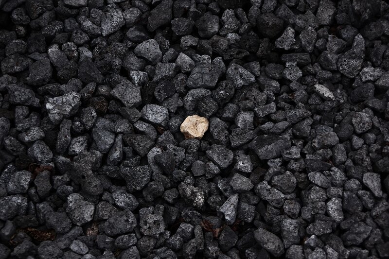 single light stone among dark gravel