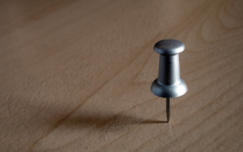 single push pin on wood